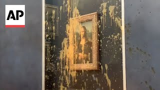 Climate activists throw soup at Mona Lisa in Paris [upl. by Meirrak548]