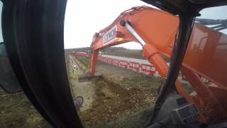 Doosan DX235LCR excavator digging out a service trench [upl. by Josh]