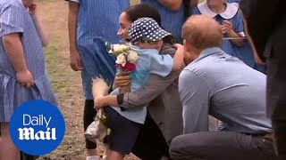 Adorable moment Harry and Meghan receive hug from young child [upl. by Earle]