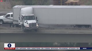 Semitruck jackknifes over edge of interstate [upl. by Hamilah519]