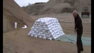 Sandbags  Building a barrier of sandbags for flood protection [upl. by Adamsun]