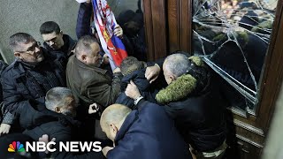 Serbia election protesters try to storm capital’s city hall [upl. by Nirihs504]