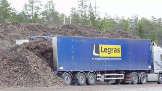 Volvo FH with Legras Moving floor trailer unloading wood [upl. by Earehs]