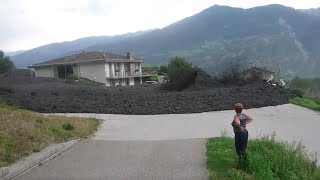 Mudslide barrels through Swiss town [upl. by Ahsiyt]