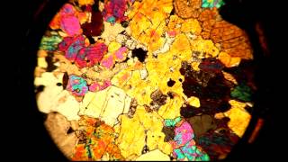 A thin section viewed through a petrographic microscope with stage rotation [upl. by Hyozo]