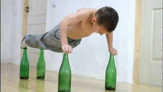 Giuliano Stroe sets world record for doing most air pushups on glass bottles [upl. by Aicenod]