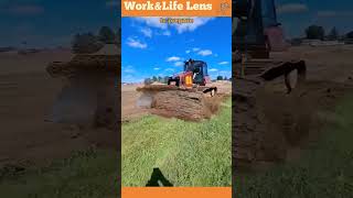 The bulldozer clears grassy terrain lifting vegetation to expose soil for construction or farming [upl. by Garrity]