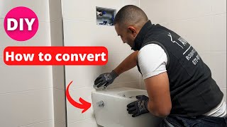 A plumber shows an existing wall toilet into a toilet with toilet shower [upl. by Gnal]