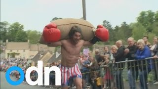 Quirky British runners race whilst carrying large sacks of wool [upl. by Rebbecca212]