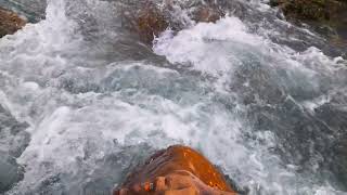 bubbling water flow of mountain river washing orange rock [upl. by Hare]