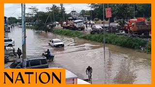 Vehicles wade through a flooded section of Kitengela town [upl. by Philo557]