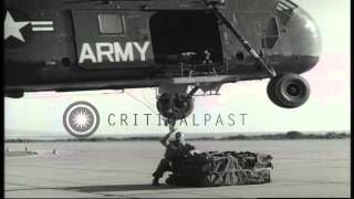 A US Army Sikorsky H34 helicopter lifts off with a load of ammunition from an aiHD Stock Footage [upl. by Ziul407]