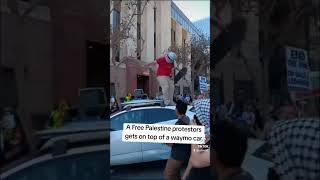 A Free Palestine protestors gets on top of a waymo car [upl. by Ytirahs]