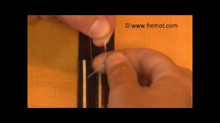 Changing Classical Guitar Strings  Winding String Around Tie Block [upl. by Nnaylime]