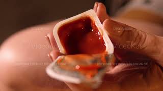 Macro footage of female hand holding open ketchup disposable package by fingers [upl. by Maighdiln]