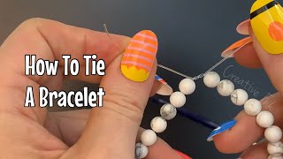 How to tie and elastic bracelet Simple and secure knot for beaded stretch bracelets [upl. by Adnihc]