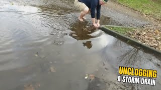 008 2 Unclogging a storm drain after rain on a car park [upl. by Rene]