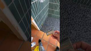 Curbless with Pebble Rocks curbless schlutershowersystems subwaytiles tiles tilecontractor [upl. by Ashlan]