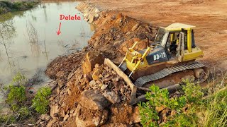 Bulldozer Pushing Rock to fill up the Small River for the land project Rock delivery by Trucks [upl. by Ahsaet]