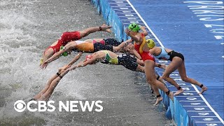 Olympic triathletes swim in Seine after water quality delay [upl. by Mich]