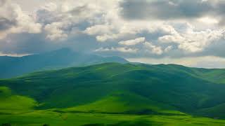 White clouds flying over green foothills at sunny summer day in Kyrgyzstan drawn point of view time [upl. by Marten705]