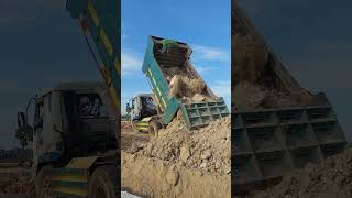 Dump truck is dumping the soil in action bulldozer dumptruck excavator [upl. by Llorrad]