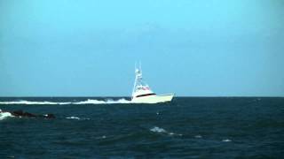 Boats 062820131  Big Sportfishing Boat Enters Rough Inlet with Jumping Spinner Sharks [upl. by Amilas]