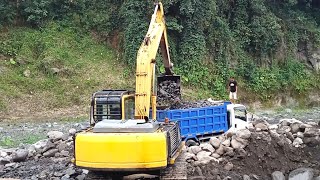 excavator working loading small stones into dump truck  sand mining [upl. by Bremen]