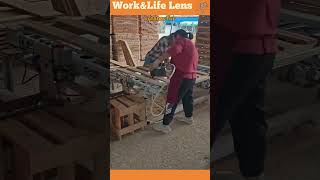 Two workers assemble pallets with a pneumatic nail gun as an automated jig rotates for efficiency [upl. by Caesaria]