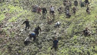 Cheese chasers launch downhill in annual British race  AFP [upl. by Aleik249]