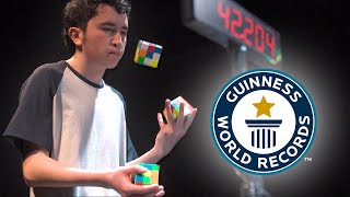 Solving Three Puzzle Cubes WHILST JUGGLING  Guinness World Records [upl. by Pandora]