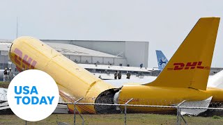 DHL cargo plane skids off runway breaks in half during rough landing  USA TODAY [upl. by Lindsay]