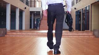 Back of view of young businessman in a suit walks with a briefcase in a businesscentre [upl. by Clothilde]