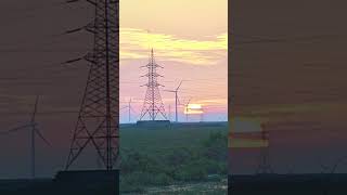 Sunset behind power wind turbines [upl. by Ladew]