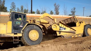 CAT 657G and 651B scrapers moving dirt  D9T Dozer ripping and pushing [upl. by Schapira]