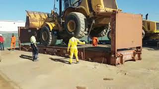 LOADING WHEEL LOADER INTO 40FT FLAT RACK SHIPPING CONTAINER [upl. by Sutniuq]