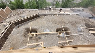 Forming for a concrete retaining wall on a steep slope [upl. by Lopez]