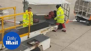 Manchester Airport staff carelessly THROW baggage onto cart [upl. by Lierbag]